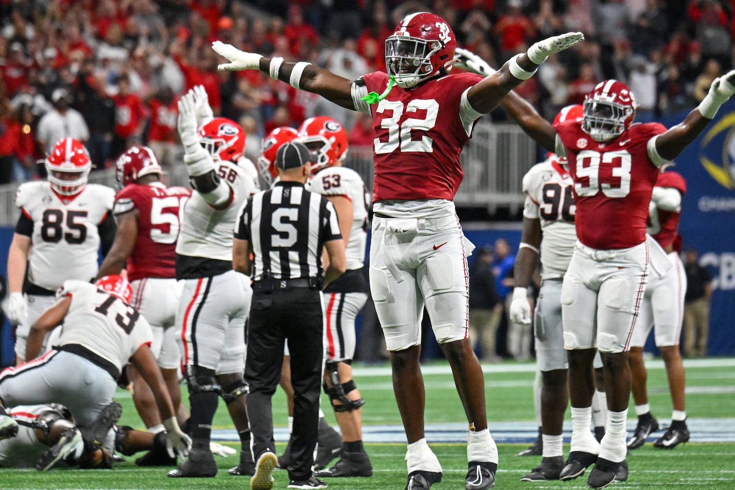 Alabama Crimson Tide defenders Deontae Lawson (32) and Jah-Marien Latham (93) signal a missed field goal by Georgia Bulldogs’ Peyton Woodring during the first half of the SEC Championship football game at the Mercedes-Benz Stadium in Atlanta, on Saturday, December 2, 2023. Alabama won 27-24.  (Hyosub Shin / Hyosub.Shin@ajc.com)