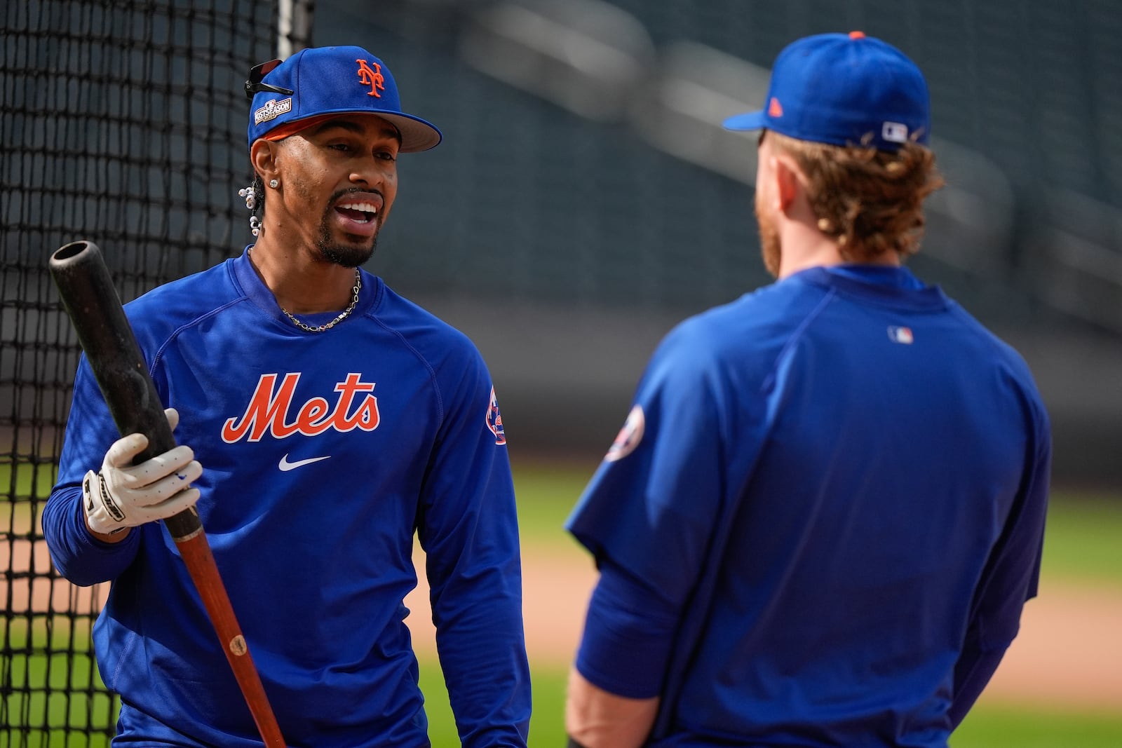 New York Mets shortstop Francisco Lindor talks to outfielder Harrison Bader during batting practice before playing against the Philadelphia Phillies in Game 3 of the National League baseball playoff series, Tuesday, Oct. 8, 2024, in New York. (AP Photo/Frank Franklin II)