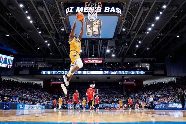 Alabama State guard Micah Octave (11) dunks during the second half of a First Four college basketball game against Saint Francis in the NCAA Tournament, Tuesday, March 18, 2025, in Dayton, Ohio. (AP Photo/Jeff Dean)