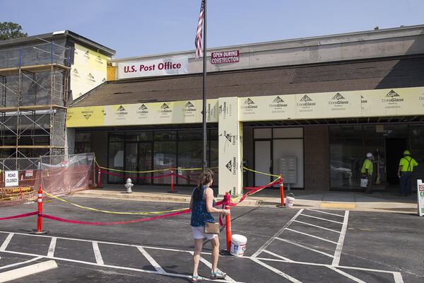 A woman walks toward a United States Post Office at the shopping center, across the street from Northlake Mall. (Alyssa Pointer/alyssa.pointer@ajc.com)