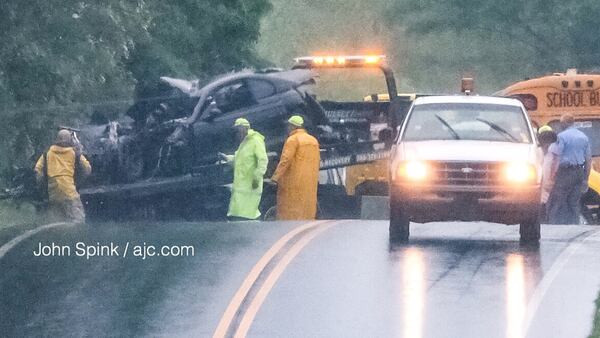 Hall County authorities work to clear a wreck involving a school bus and a car Wednesday morning.  JOHN SPINK / JSPINK@AJC.COM