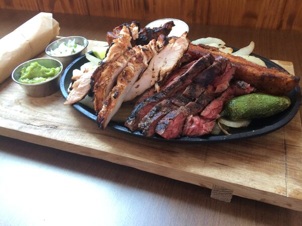 The Parilla Mixta Fajita at Superica includes beef and chicken fajitas, carnitas, guacamole, smoked onion salsa fresca, Mexican butter and house-made flour tortilllas. Photo: Ligaya Figueras