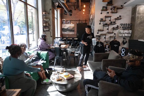 Shanise McGill helps customers at Brooklyn Tea, Friday, Oct. 11, 2024, in Atlanta. (Hyosub Shin / AJC)