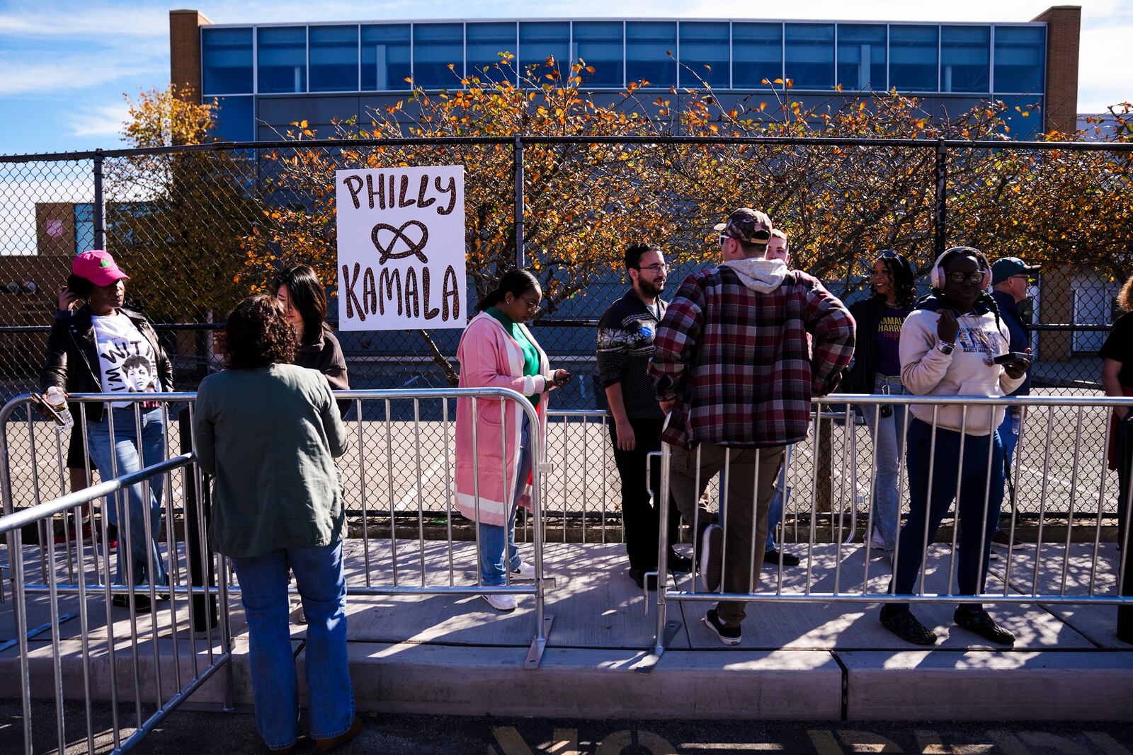 People wait in line to attend a Democratic presidential nominee Vice President Kamala Harris campaign event in Philadelphia, Sunday, Oct. 27, 2024. (AP Photo/Matt Rourke)