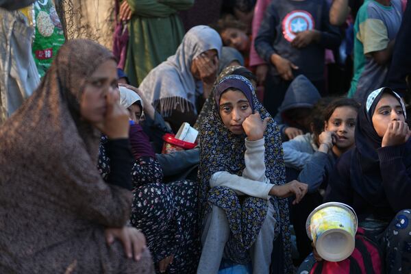 Palestinians queue for food in Deir al-Balah, Gaza Strip, Monday, Nov. 18, 2024. (AP Photo/Abdel Kareem Hana)