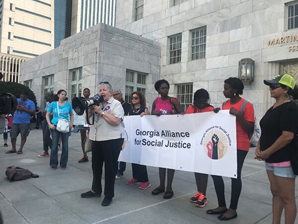 State Sen. Nan Orrock, D-Atlanta, tells the crowd now is not the time to give up. She urged people to turn out for gubernatorial candidate Stacey Abrams in next month's election. “We are going to get so damn engaged in the political process in this country they’re not going to know what hit them,” she says to cheering crowd at the protest in opposition to Judge Brett Kavanaugh's Supreme Court nomination. “We will win.” (Photo: MERIS LUTZ/AJC)