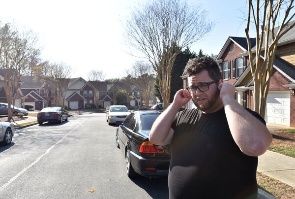 Patrick O’Haley covers his ears as he discusses the noise caused by the Atlanta Police Department’s firing range located next to his subdivision in DeKalb County. (Photo: HYOSUB SHIN / HSHIN@AJC.COM)