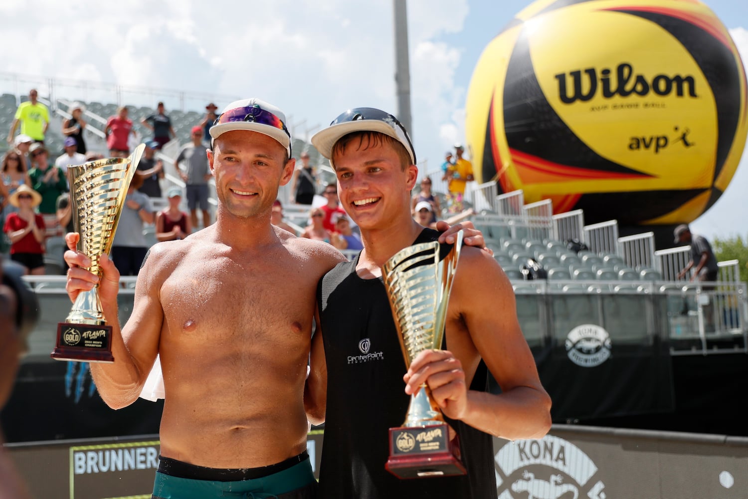 Paul Lotman and Miles Partain hold their trophies after winning the AVP Gold Series Atlanta Open beach volleyball men's championship match Sunday at Atlantic Station. (Miguel Martinez / miguel.martinezjimenez@ajc.com)