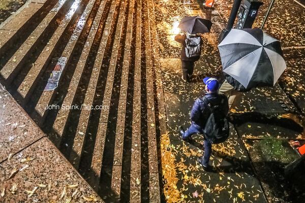 Rain and temperatures were falling Tuesday morning at the North Avenue MARTA station.