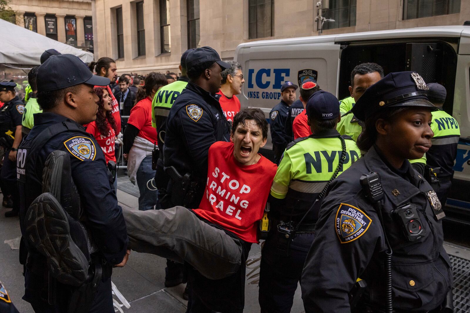 Police officers a demonstrator protesting Israel's war against Hamas as they occupy an area outside the New York Stock Exchange, Monday, Oct. 14, 2024, in New York. (AP Photo/Yuki Iwamura)