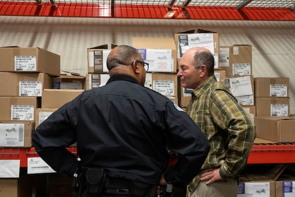 Assistant Chief of Police for the Vancouver Police Department Troy Price, left, talks with Greg Kimsey, the longtime elected auditor in Clark County, Wash., after a news conference at the Multnomah County Elections Division office on Monday, Oct. 28, 2024, in Portland, Ore. (AP Photo/Jenny Kane)