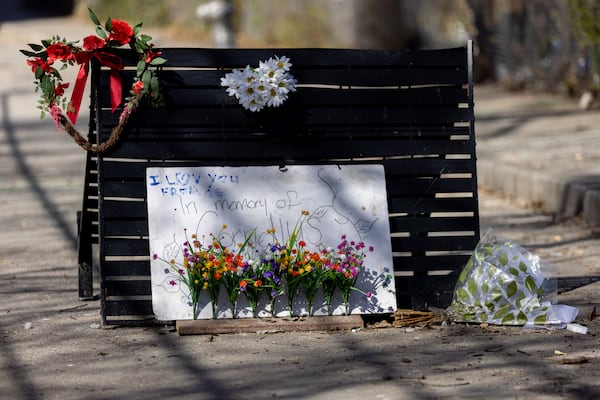 A memorial to Cornelius Taylor is seen at an encampment on Old Wheat Street in Atlanta on Wednesday, March 12, 2025, as Tony Atwater, right, looks on. Daniel Barnett was arrested on Tuesday for allegedly slashing tents at the encampment, which is also where Taylor was killed during a clearing in January. (Arvin Temkar / AJC)