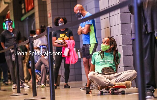 Voters wait in line at State Farm Arena in Atlanta on Oct. 12, 2020. JOHN SPINK / JOHN.SPINK@AJC.COM