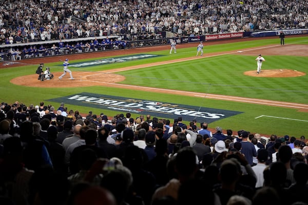 Los Angeles Dodgers' Freddie Freeman, left, hits a two-run single off New York Yankees starting pitcher Gerrit Cole, right, during the fifth inning in Game 5 of the baseball World Series, Wednesday, Oct. 30, 2024, in New York. (AP Photo/Seth Wenig)