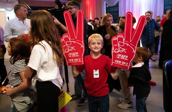 Samuel Towe, 8, holds up two pro-Amendment 2 foam fingers as he attends the Americans for Prosperity—Kentucky's rally featuring U.S. Sen. Rand Paul, and others in support of Kentucky's Amendment 2 with his family at La Gala in downtown Bowling Green, Ky., Monday, Oct. 28, 2024. (Grace Ramey McDowell/Daily News via AP)