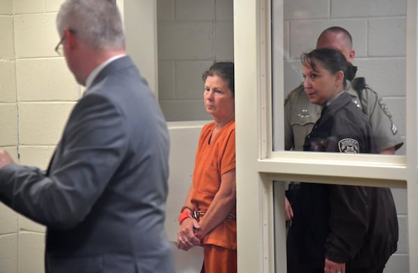 Melody Farris is escorted in for her first appearance as her attorney Michael Ray (left) looks on at Cherokee County Magistrate Court on June 21, 2019. HYOSUB SHIN / HSHIN@AJC.COM