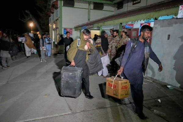 Passengers rescued by security forces from a passenger train attacked by insurgents arrive at a railway station in Much, Pakistan's southwestern Balochistan province, Thursday March 13, 2025. (AP Photo/Anjum Naveed)