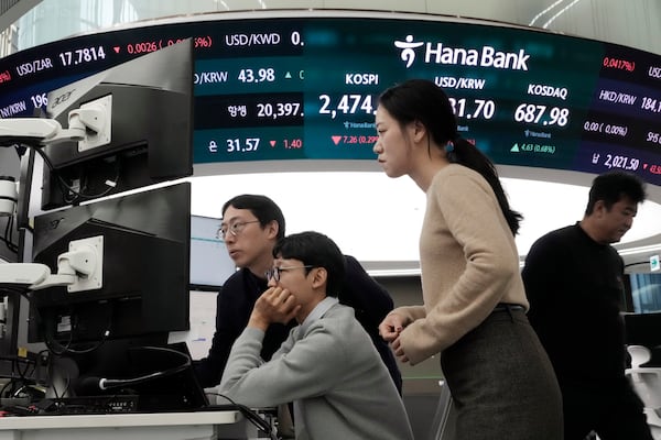 Currency traders watch monitors at the foreign exchange dealing room of the KEB Hana Bank headquarters in Seoul, South Korea, Friday, Dec. 13, 2024. (AP Photo/Ahn Young-joon)