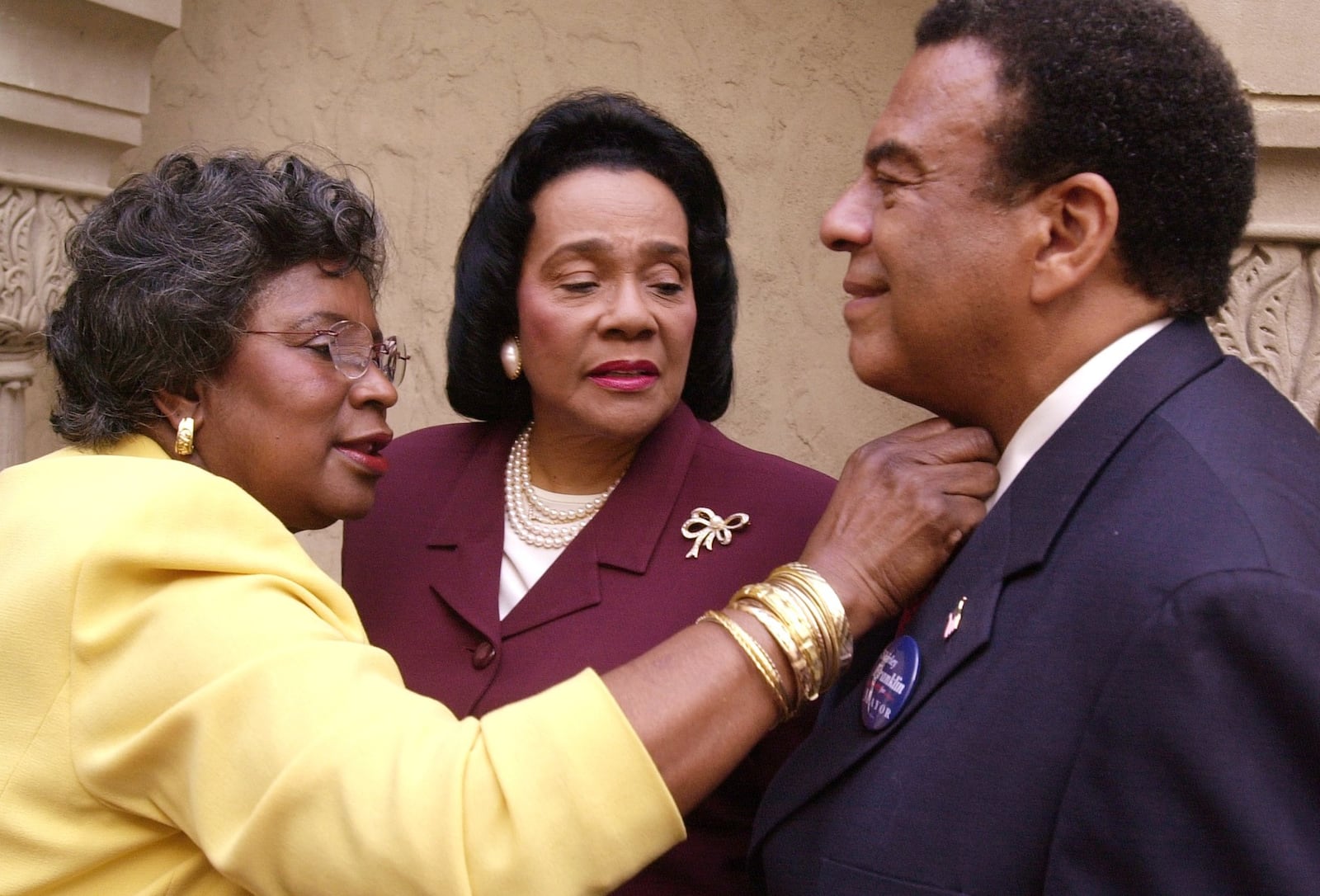 Juanita Jones Abernathy  widow of Reverend Ralph David Abernathy, fixes the tie of former US Ambassador as  Coretta Scott King,  inspects the situation. RICH ADDICKS/STAFF