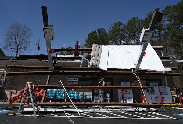 Workers clean up at Texaco gas station on Villa Rica Hwy after a storm passed through, Sunday, March 16, 2025, in Dallas. National Weather Service teams will be conducting a damage survey in the Paulding County/Dallas area, which sustained “pretty significant” damage from the storms, NWS Senior Meteorologist Dylan Lusk told The Atlanta Journal-Constitution on Sunday morning. (Hyosub Shin / AJC)