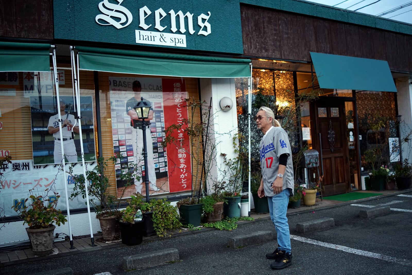 Hironobu Kanno, representative of a private fan club of Shohei Ohtani of the Los Angeles Dodgers, speaks at his beauty salon in Oshu, northeastern Japan, the hometown of Ohtani, Tuesday, Oct. 29, 2024. (AP Photo/Eugene Hoshiko)