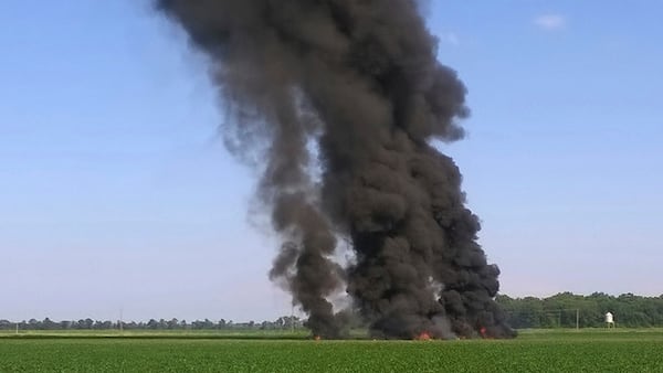 In this photo provided by Jimmy Taylor, smoke and flames rise into the air after a military transport airplane crashed in a field near Itta Bena, Miss., on the western edge of Leflore County, Monday, July 10, 2017, killing several. (Jimmy Taylor via AP)