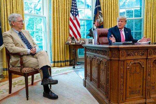 Senate Majority Leader Mitch McConnell of Ky., listens as President Donald Trump speaks during a meeting in the Oval Office of the White House, Monday, July 20, 2020, in Washington. (AP Photo/Evan Vucci)