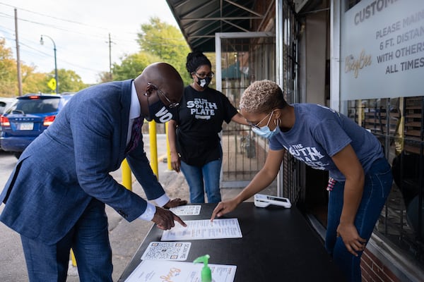 201021-Atlanta- Rev. Raphael Warnock orders baked chicken at the Busy Bee Café in the West End after voting at State Farm Arena on Wednesday, October 21, 2020. Ben Gray for the Atlanta Journal-Constitution