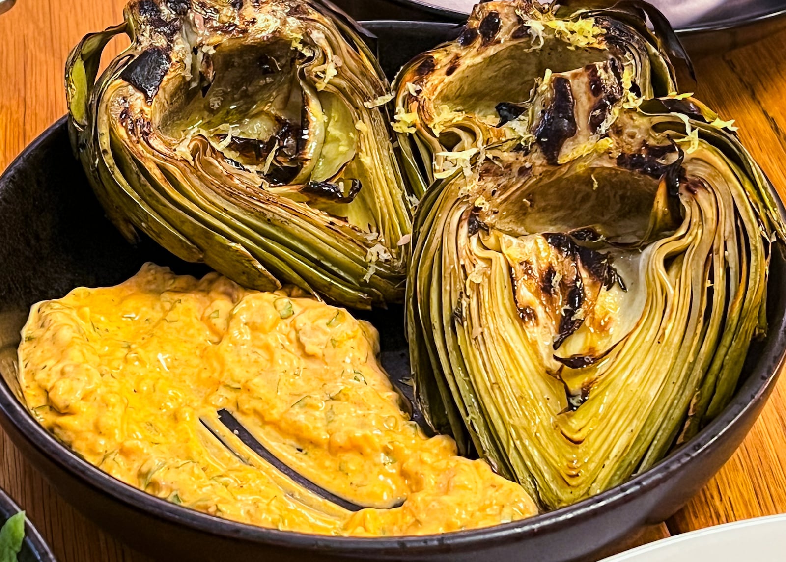 Bocado's grilled artichokes are a fun, messy finger food. (Henri Hollis/AJC)