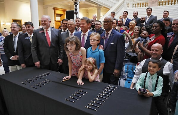 April 17, 2019 - Atlanta -  Gov. Brian Kemp stood for a photo with medical marijuana users and advocates after the signing.  Kemp signed HB 324 Wednesday, a bill that will allow medical marijuana oil to be sold in Georgia for the first time. The legislation would provide a way for the state's 9,000-plus medical marijuana patients to buy the drug they're already allowed to use.   Bob Andres / bandres@ajc.com