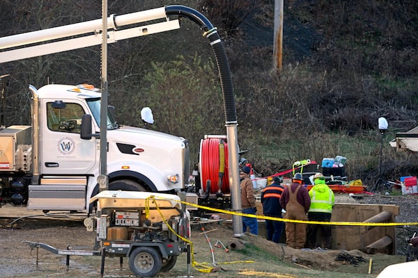 Rescue workers continue to search, Wednesday, Dec. 4, 2024, for Elizabeth Pollard, who is believed to have disappeared in a sinkhole while looking for her cat, in Marguerite, Pa. (AP Photo/Gene J. Puskar)