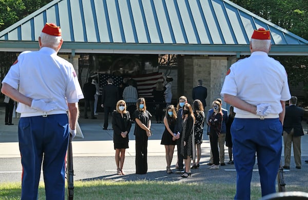 Family members watch the Woodstock detachment of the Marine Corps League's Ceremonial Rifle Team during a funeral service for Navy veteran Howard Orr of Johns Creek (Hyosub Shin / Hyosub.Shin@ajc.com)