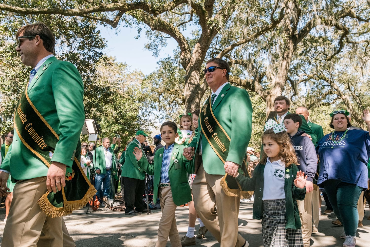 Members of the 2025 St. Patrick’s Day Parade Committee walk toward the fountain in Forsyth Park during the annual dying of the fountain on March 7, 2025 in Savannah, GA. The dying of the fountain marks the beginning of the city’s St. Patrick’s Day festivities. (Justin Taylor/The Atlanta Journal Constitution)