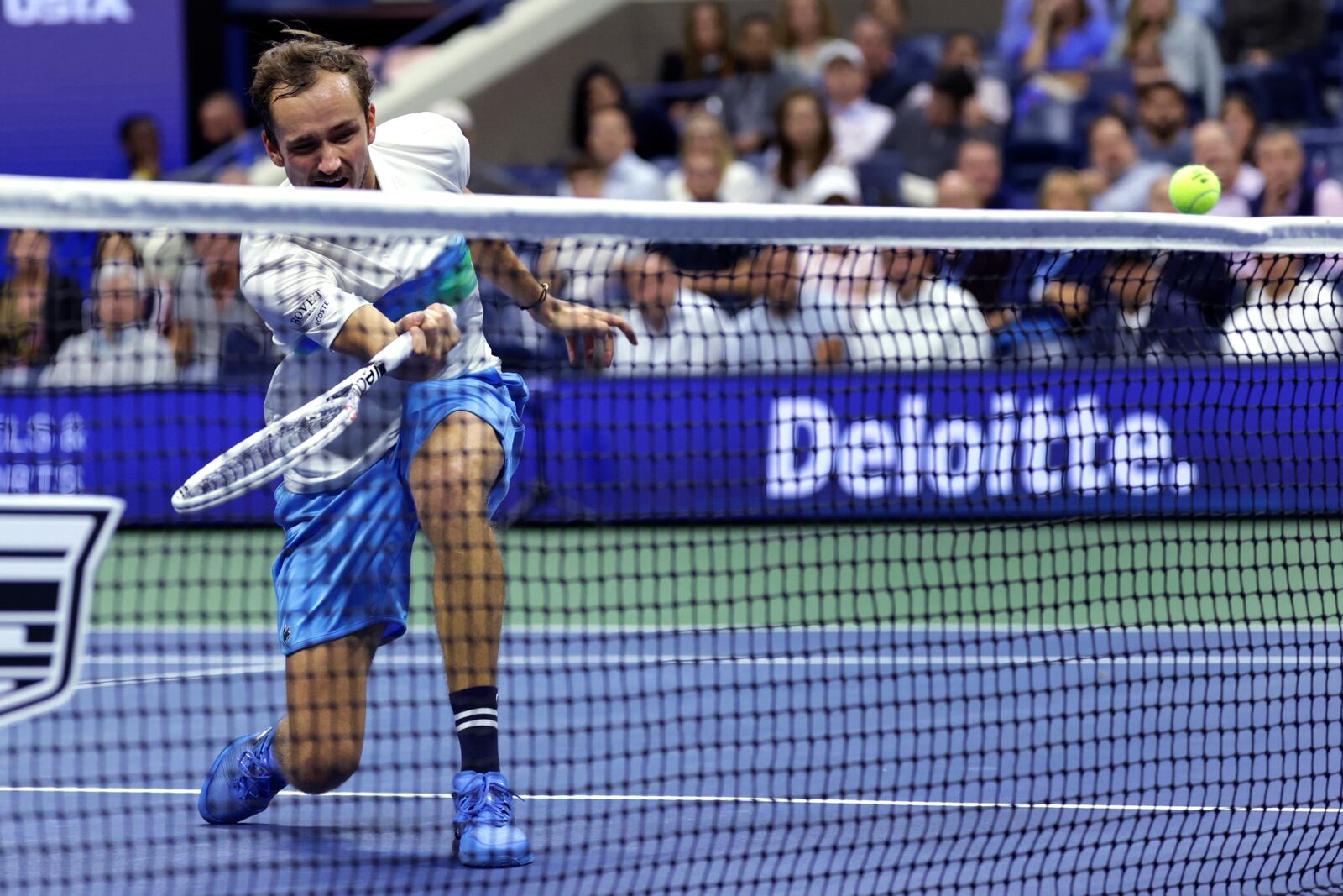 Daniil Medvedev, of Russia, follows through on a shot, which fails to clear the net, during his match against Jannik Sinner, of Italy, during the quarterfinals of the U.S. Open tennis championships, Wednesday, Sept. 4, 2024, in New York. (AP Photo/Adam Hunger)