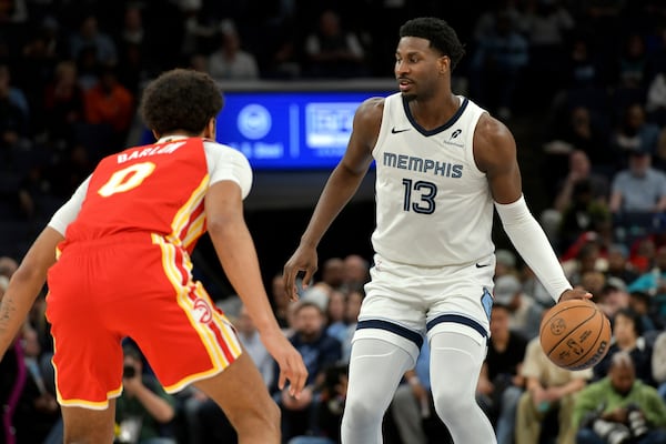 Memphis Grizzlies forward Jaren Jackson Jr. (13) handles the ball against Atlanta Hawks forward Dominick Barlow (0) in the first half of an NBA basketball game, Monday, March 3, 2025, in Memphis, Tenn. (AP Photo/Brandon Dill)