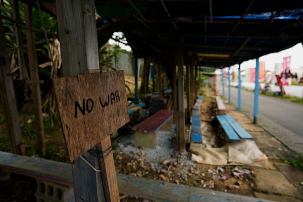 A sign is placed across from Camp Schwab, a U.S. Marine Corps base in Nago, on the main island of the Okinawa archipelago, southern Japan, Tuesday, Feb. 18, 2025. (AP Photo/Hiro Komae)