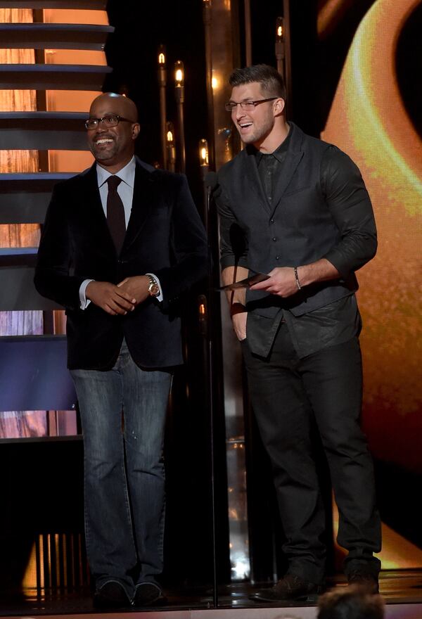 NASHVILLE, TN - NOVEMBER 05: Darius Rucker and Tim Tebow present during the 48th annual CMA Awards at the Bridgestone Arena on November 5, 2014 in Nashville, Tennessee. (Photo by Rick Diamond/Getty Images) Darius Rucker (with Tim Tebow).