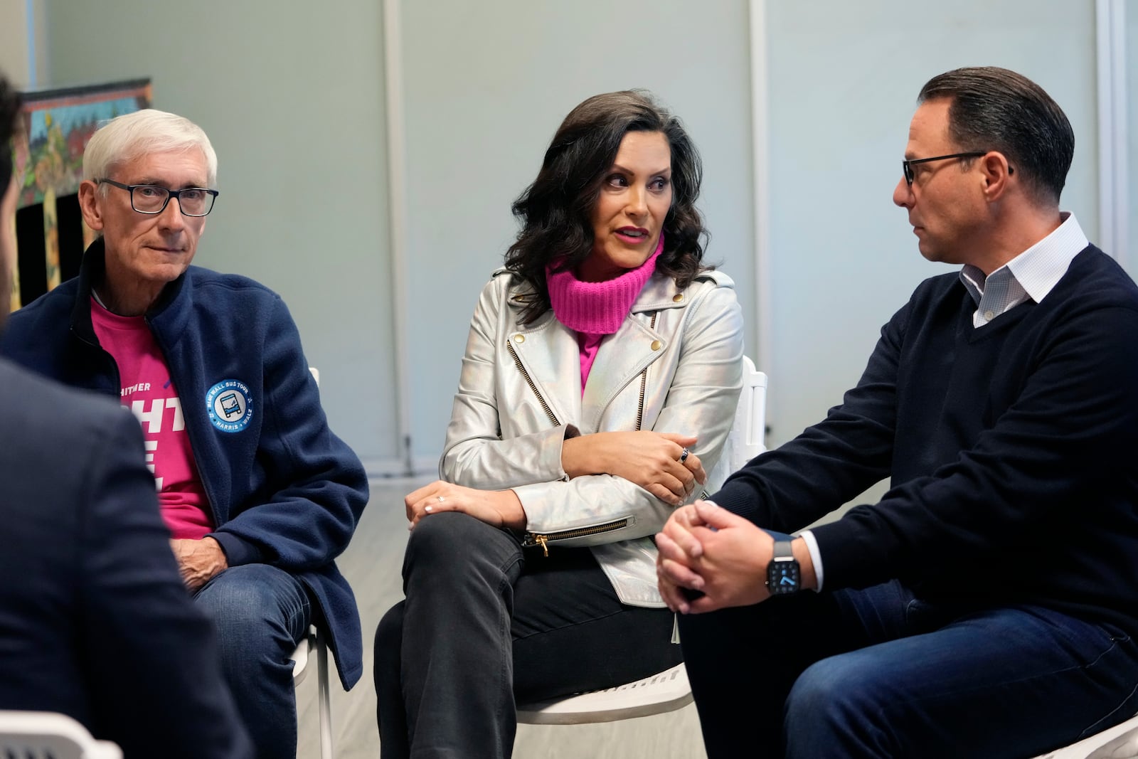 Wisconsin Gov. Tony Evers, left, Michigan Gov. Gretchen Whitmer and Pennsylvania Gov. Josh Shapiro talk during a campaign event, Thursday, Oct. 17, 2024, in Flint, Mich. (AP Photo/Carlos Osorio)