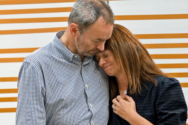 FILE - Simon and Sally Glass comfort each other during an emotional news conference about the death of their son, Christian Glass, in Denver, Sept. 13, 2022. (AP Photo/Thomas Peipert, File)