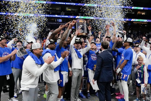 Florida head coach Todd Golden and players celebrate victory over Tennessee after an NCAA college basketball game in the final round of the Southeastern Conference tournament, Sunday, March 16, 2025, in Nashville, Tenn. (AP Photo/George Walker IV)