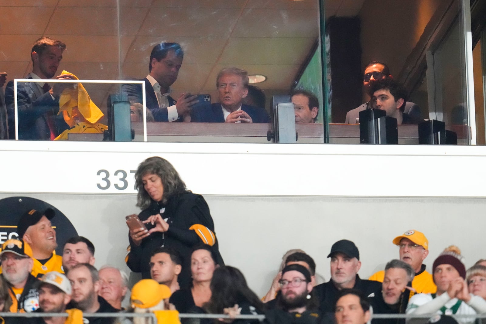 Republican presidential nominee former President Donald Trump watches the first half of an NFL football game between the Pittsburgh Steelers and the New York Jets in Pittsburgh, Sunday, Oct. 20, 2024. (AP Photo/Gene J. Puskar)