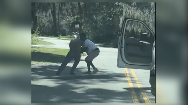 Stills from a video released today online show Ahmaud Arbery trying to disarm Travis McMichael. Arbery collapsed to the ground a few moments later, never to regain conciousness.