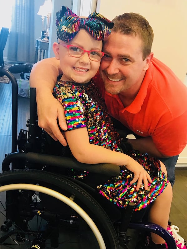 Anna Charles Hollis with her father, Benji Hollis, a longtime employee of Peach Bowl Inc. Her family worked to make her five months in the hospital as happy and loving as possible. CONTRIBUTED