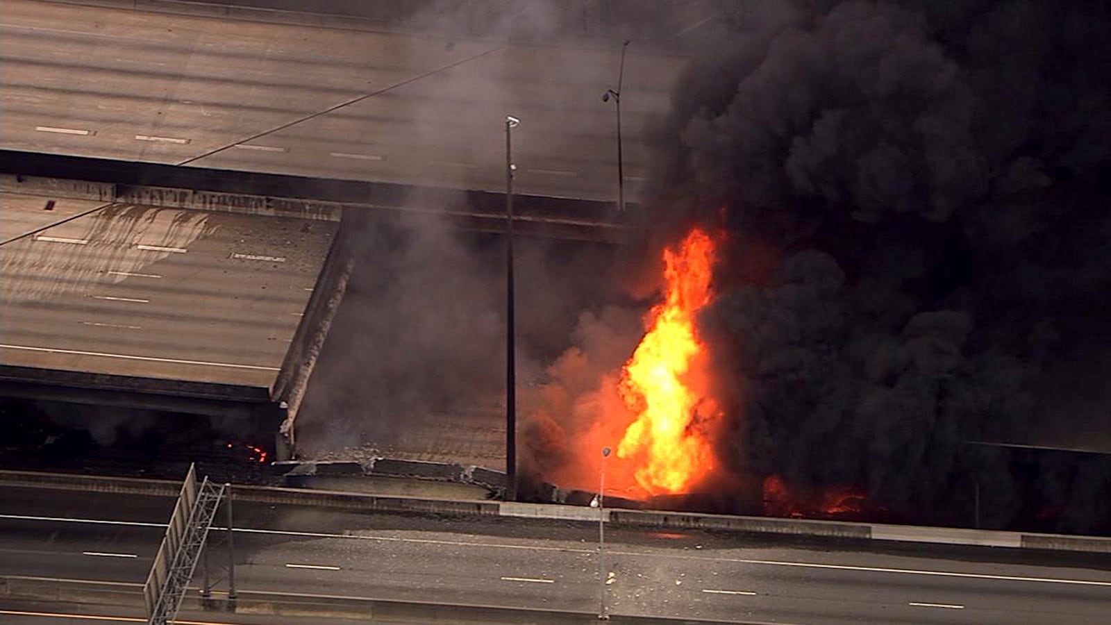 In this aerial image made from a video provided by WSB-TV, a large fire that caused an overpass on Interstate 85 to collapse burns in Atlanta, Thursday, March 30, 2017. Witnesses say troopers were telling cars to turn around on the bridge because they were concerned about its integrity. Minutes later, the bridge collapsed. (WSB-TV via AP) MANDATORY CREDIT, ATLANTA TV OUT