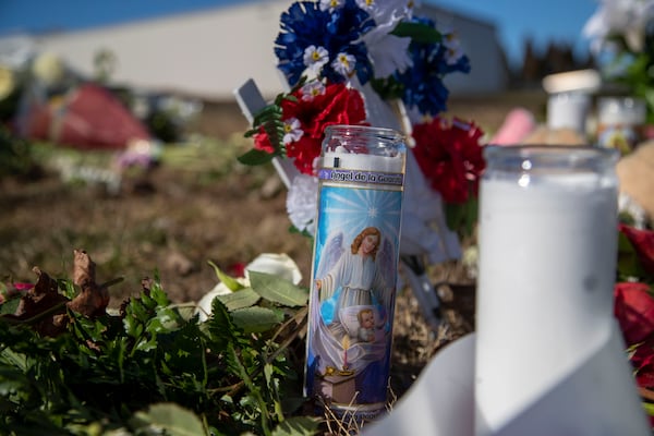 Flowers, candles, notes and stuffed animals are displayed at a makeshift vigil outside of the Foundation Food Group in Gainesville on February 2, 2021. Six people died while working at the plant, January 28, when a liquid nitrogen line ruptured. Five people died at the scene on Memorial Park Drive, and 12 others were taken to the emergency room at Northeast Georgia Medical Center with injuries, officials said. One of those patients died at the hospital. (Alyssa Pointer / Alyssa.Pointer@ajc.com)