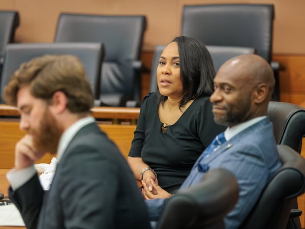 District Attorney Fani Willis (center) reacts to proceedings at Fulton County Superior Court on Thursday, July 21, 2022. State Sen. Burt Jones filed a motion to remove Willis from the Fulton County Trump investigation because she held a fundraiser for Jones’ Democratic opponent Charlie Bailey. (Arvin Temkar / arvin.temkar@ajc.com)