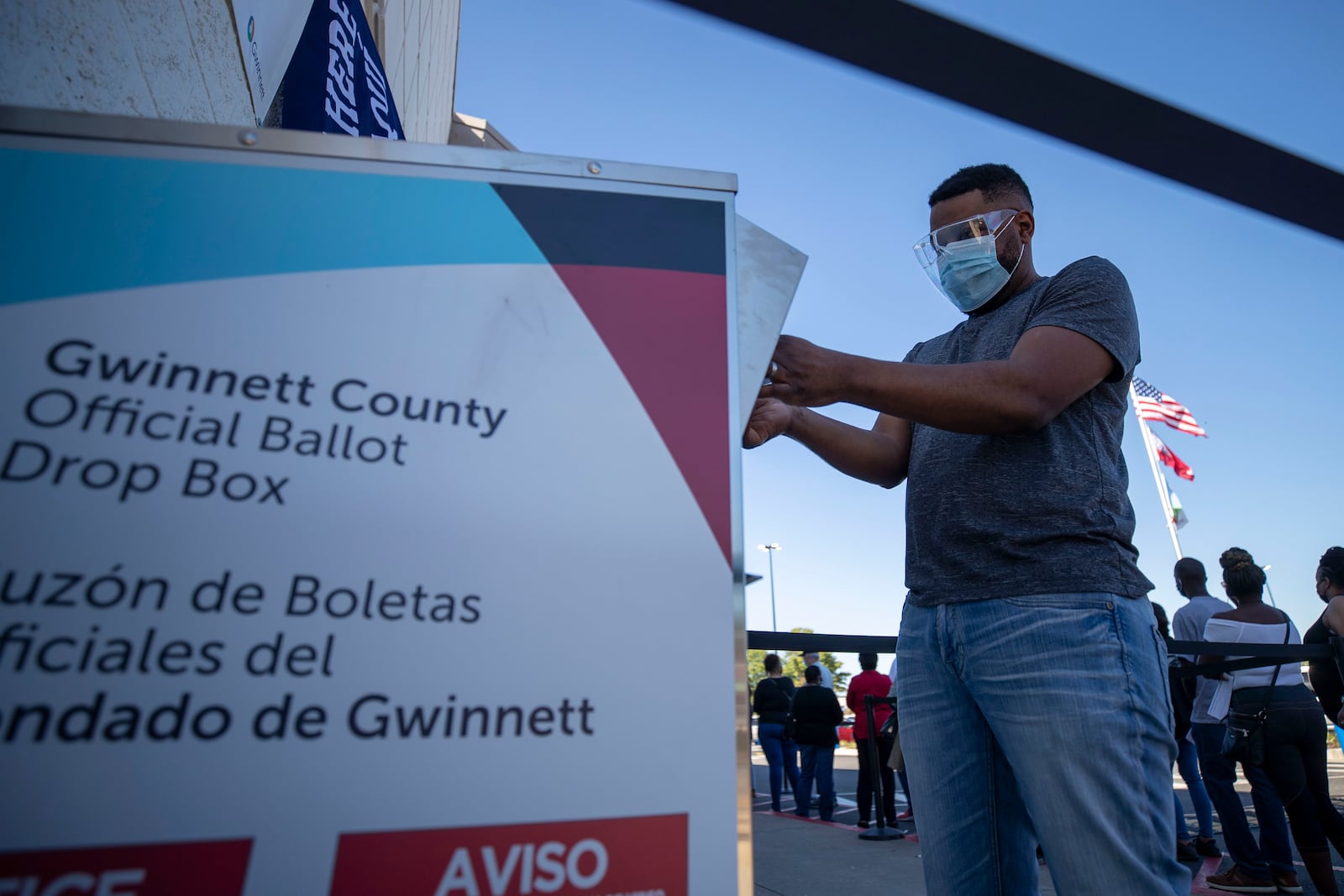 A Gwinnett County resident places his absentee ballot inside an official drop box at the Gwinnett County Voter Registration and Elections Building in Lawrenceville in October 2020. (AJC File)