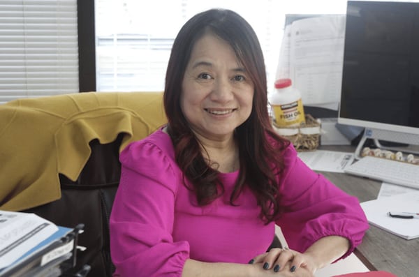 Trinh Pham, executive director of Boat People SOS’s Atlanta chapter, sits at her desk in her office in Norcross, Georgia. (Photo Courtesy of Sophia Qureshi)