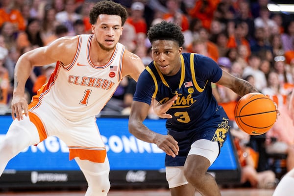 Notre Dame guard Markus Burton (3) drives past Clemson guard Chase Hunter (1) during the first half of an NCAA college basketball game, Wednesday, Feb. 26, 2025, in Clemson, S.C. (AP Photo/Scott Kinser)