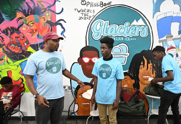 Ian Elmore-Moore (left), executive director, instructs Chris Brown, 14, as B.J. Sexton (right), 15, prepares for festivals where they sell their ice creams at Glacier Italian Ice, Friday, May 19, 2023, in Atlanta. (Hyosub Shin / Hyosub.Shin@ajc.com)